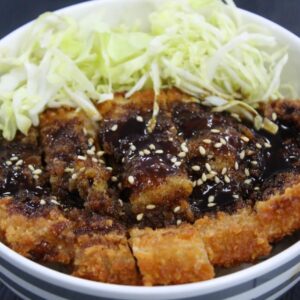 Pork tonkatsu served with rice, shredded cabbage, and dipping sauce