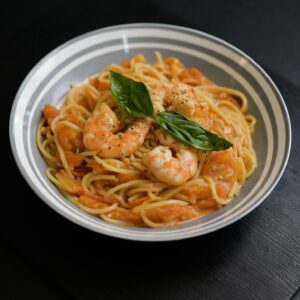 Shrimp pasta served in a bowl with creamy sauce and seasoned shrimp