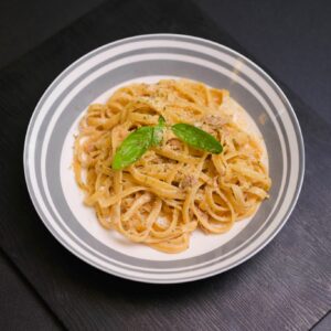 Tuna pasta served in a bowl with creamy sauce and herbs